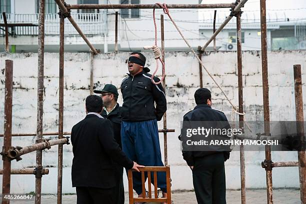 Balal, who killed Iranian youth Abdolah Hosseinzadeh in a street fight with a knife in 2007, reacts as he stands in the gallows during his execution...