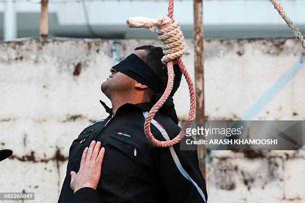 Balal, who killed Iranian youth Abdolah Hosseinzadeh in a street fight with a knife in 2007, is pictured blindfolded next to a noose during his...