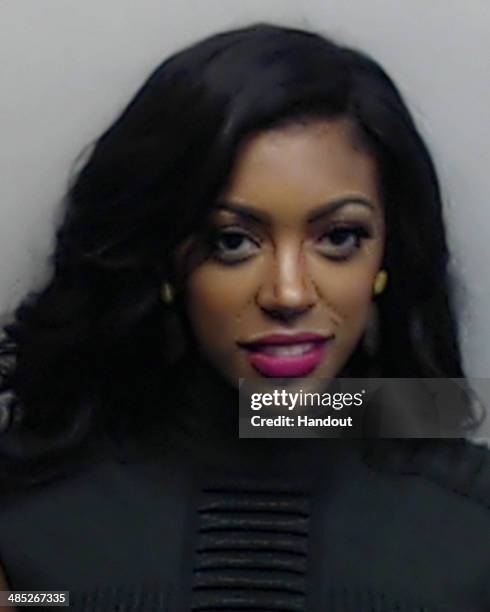 In this handout photo provided by Fulton County Sheriff's Office, The Real Housewives of Atlanta Porsha Williams poses for a police booking photo at...