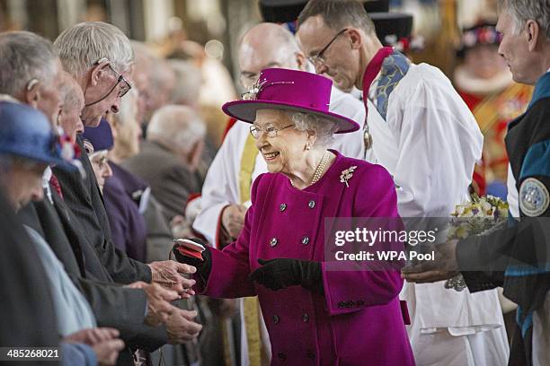 Queen Elizabeth II greets parishioners as she leaves Blackburn Cathedral after attending the Royal Maundy Service on April 17, 2014 in Blackburn,...