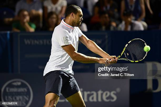 Jo-Wilfried Tsonga of France returns a shot from Denis Istomin of Uzbekistan during the second day of the Winston-Salem Open at Wake Forest...