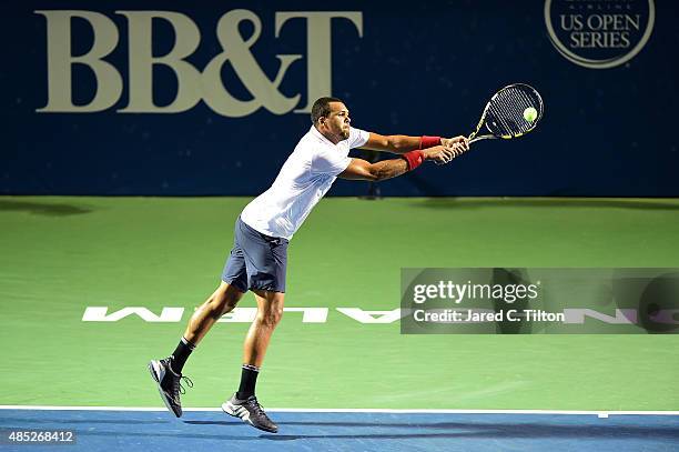 Jo-Wilfried Tsonga of France returns a shot from Denis Istomin of Uzbekistan during the second day of the Winston-Salem Open at Wake Forest...