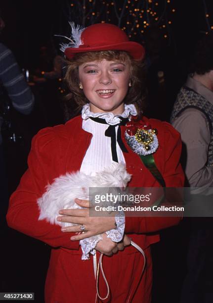 Show "The Love Boat" star Jill Whelan holds her tiny dog as she attends the Hollywood Christmas Parade in December 1980 in Los Angeles, California.