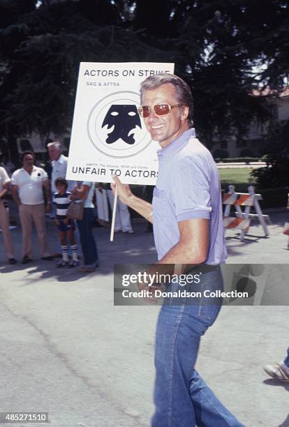 Actor Lyle Waggoner holds a protest sign in July 1980 in Los Angeles, California.