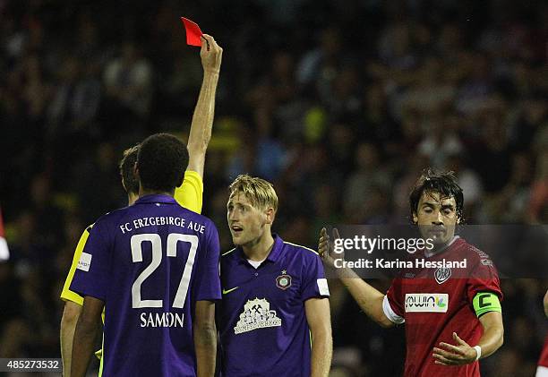 Referee Lasse Koslowski shows the red card to Bjoern Kluft of Aue during the Third League match between FC Erzgebirge Aue and VFR Aalen at...