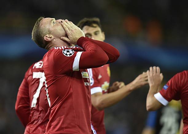 Manchester's Wayne Rooney celebrates after scoring the opening goal during the UEFA Champions League play-off round second leg football match between...