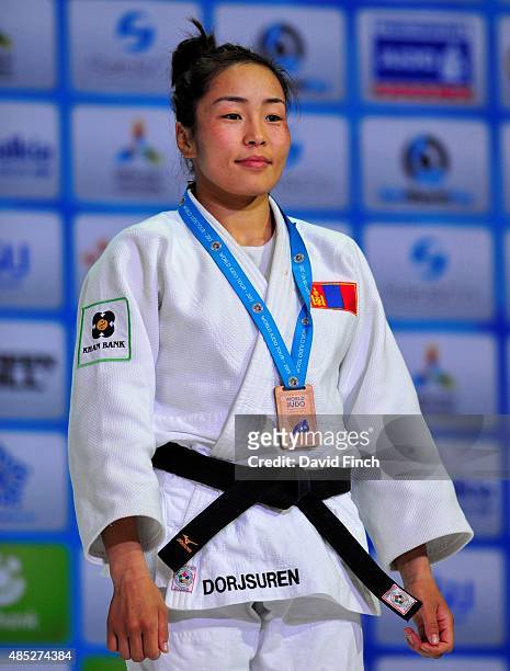 Under 57kg bronze medallist, Sumiya Dorjsuren of Mongolia standing during the Japanese national anthem at the 2015 Astana World Judo Championships at...