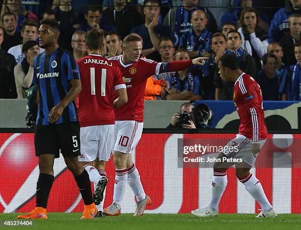 Wayne Rooney of Manchester United celebrates scoring their first goal during the UEFA Champions League play-off second leg match between Club Brugge...