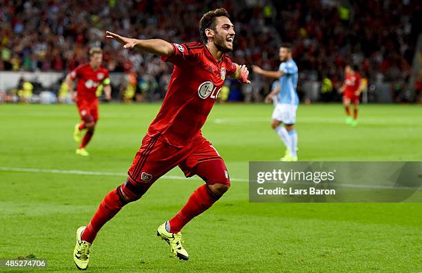 Hakan Calhanoglu of Bayer Leverkusen celebrates after scoring his teams first goal during the UEFA Champions League qualifying play off round 2nd leg...