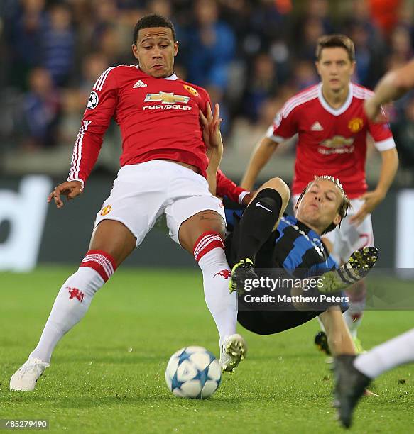 Memphis Depay of Manchester United in action with Ruud Vormer of Club Brugge during the UEFA Champions League play-off second leg match between Club...