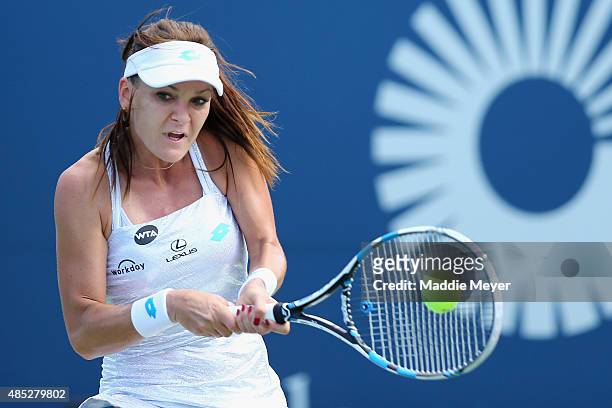 Agnieszka Radwanska of Poland returns a backhand to Alize Cornet of France on Day 3 of the Connecticut Open at Connecticut Tennis Center at Yale on...