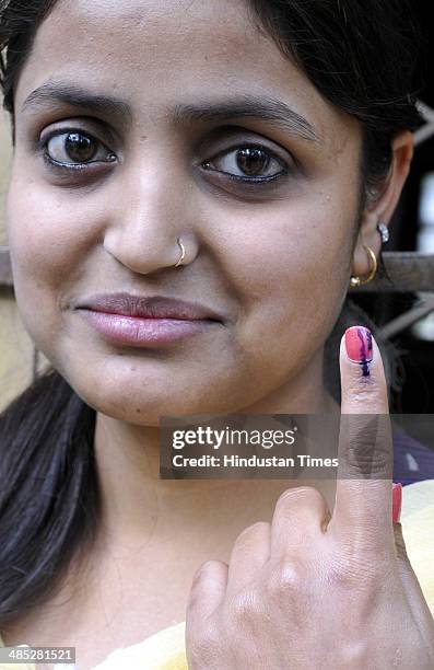 Girl showing her ink marked fingure after cast her vote at polling station set up inside a school in Doda on April 17, 2014 in Jammu, India. India is...