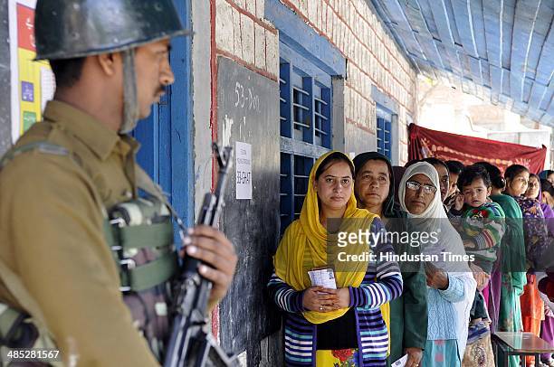 Voters stands in a queue to cast their vote in a polling station at Ghat village, Doda on April 17, 2014 in Jammu, India. India is headed for 9-phase...