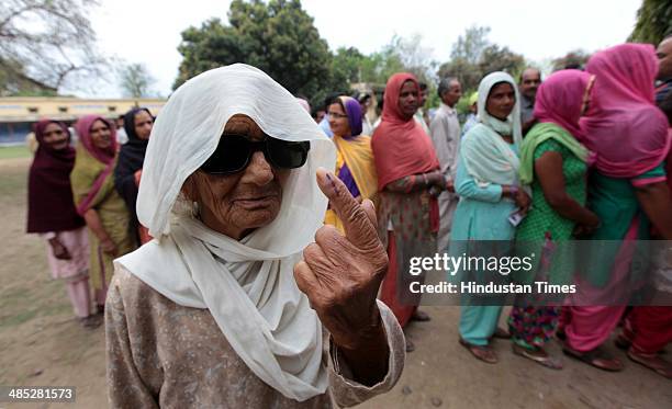 An old lady showing her ink marked fingure after cast her vote in a polling station at Heera Nagar on April 17, 2014 in Jammu, India. India is headed...