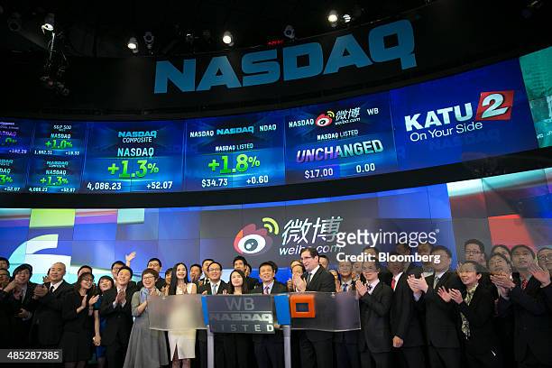 Charles Chao, chief executive officer of Sina Corp., center, attends an IPO ceremony for Weibo Corp. At the Nasdaq MarketSite in New York, U.S., on...