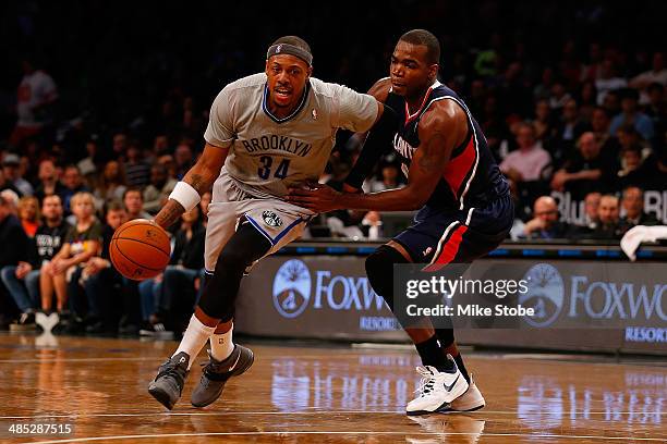 Paul Pierce of the Brooklyn Nets drives towards the net against Paul Millsap of the Atlanta Hawks at Barclays Center on April 11, 2014 in New York...