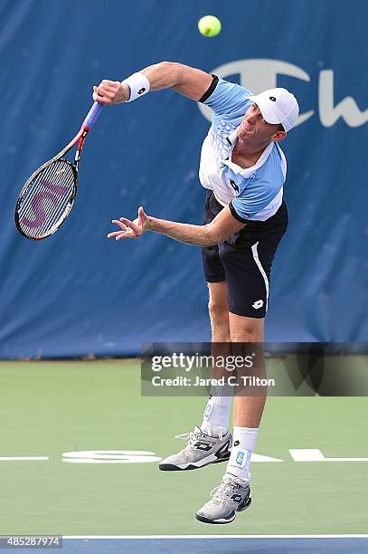 Kevin Anderson of South Africa serves to Jerzy Janowicz of Poland during the third day of the Winston-Salem Open at Wake Forest University on August...