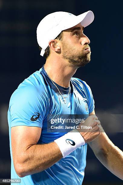 Steve Johnson reacts after defeating Jo-Wilfried Tsonga of France during the third day of the Winston-Salem Open at Wake Forest University on August...