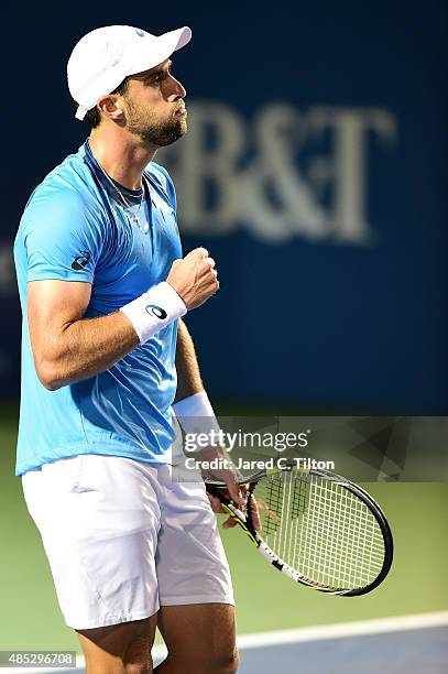 Steve Johnson reacts after defeating Jo-Wilfried Tsonga of France during the third day of the Winston-Salem Open at Wake Forest University on August...