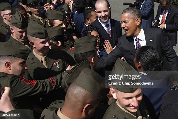 President Barack Obama greets Marines during the kickoff of the seventh annual Wounded Warrior Project's Soldier Ride on the driveway of the South...