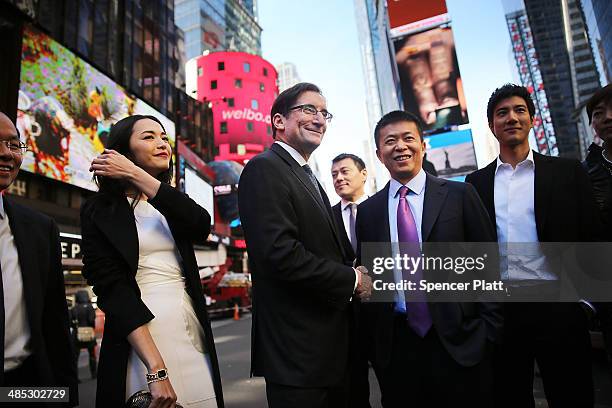 China's Weibo CEO Charles Chao stands with Robert Greifeld, Nasdaq CEO, moments after Weibo began trading on the Nasdaq exchange under the ticker...