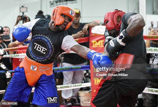 Boxer Floyd Mayweather Jr. Spars with boxer Don Moore during a media workout at the Mayweather Boxing Club on August 26, 2015 in Las Vegas, Nevada....