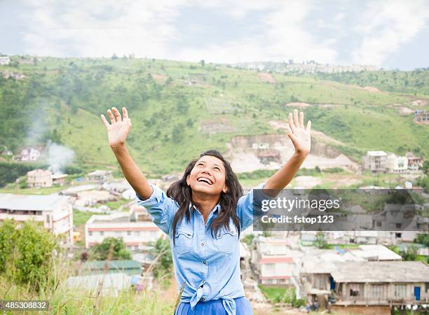 praise!  asian girl gives thanks as she lifts arms upward. - kid praying stock pictures, royalty-free photos & images