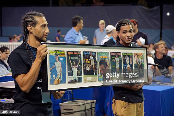 Framed cover photos of John McEnroe being auctioned in between the Johnny Mac Tennis Project 2015 Benefit Matches at Randall's Island on August 26,...