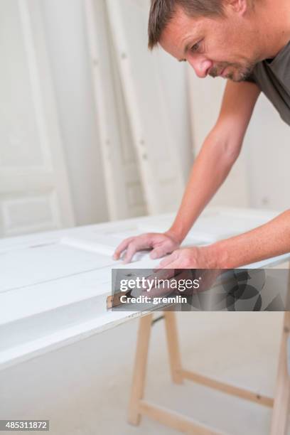 man restorating old wooden doors - sand paper stock pictures, royalty-free photos & images