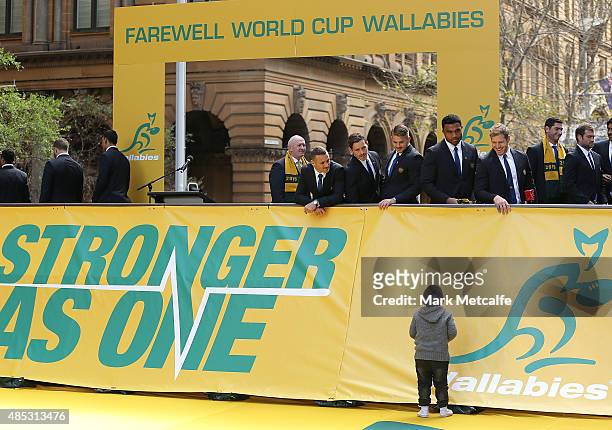 Wallabies players intearact with a young fan during the Australia Rugby World Cup farewell fan day at Martin Place on August 27, 2015 in Sydney,...