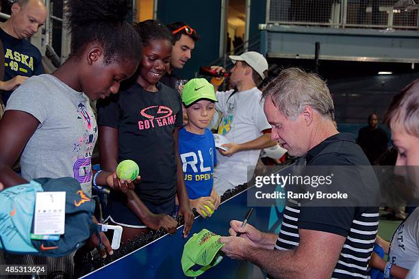 Patrick McEnroe signs autographs after the Johnny Mac Tennis Project 2015 Benefit Matches at Randall's Island on August 26, 2015 in New York City.