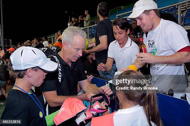 John McEnroe signs autographs after the Johnny Mac Tennis Project 2015 Benefit Matches at Randall's Island on August 26, 2015 in New York City.