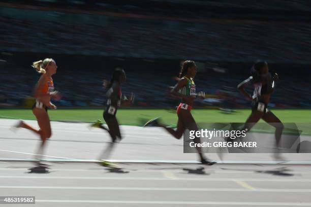Netherlands' Susan Kuijken, Kenya's Irene Chepet Cheptai, Ethiopia's Genzebe Dibaba and Kenya's Mercy Cherono compete in a heat of the women's 5000...
