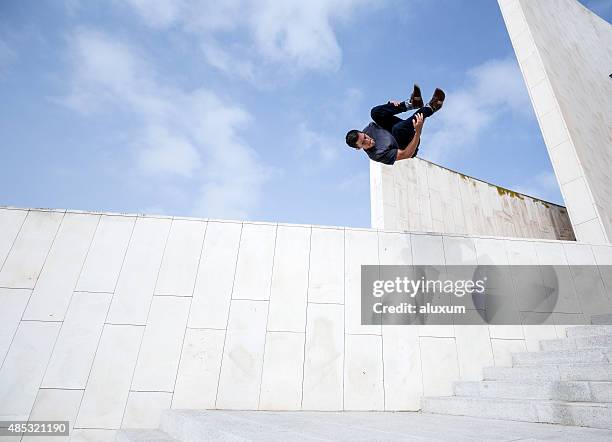 young man practicing parkour in the city - free running stock pictures, royalty-free photos & images