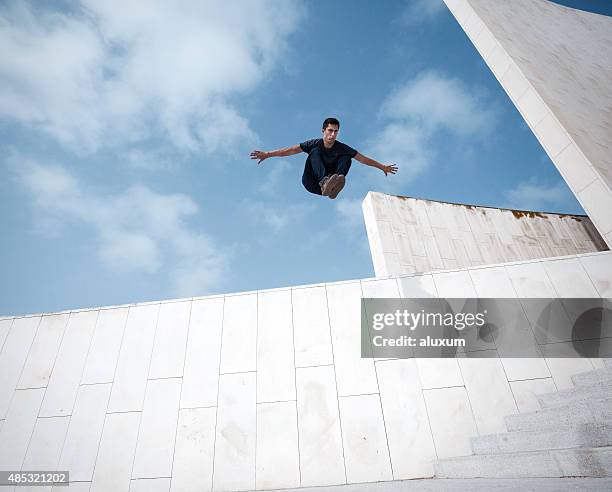 young man practicing parkour in the city - mens field event 個照片及圖片檔