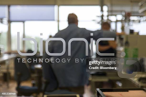 Glass panel displays a "Bionic Technology by Ossur" sign at the Ossur HF manufacturing plant in Reykjavik, Iceland, on Tuesday, Aug. 11, 2015. Ossur...