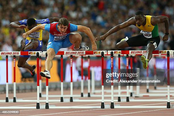 Shane Brathwaite of Barbados, Sergey Shubenkov of Russia and Hansle Parchment of Jamaica compete in the Men's 110 metres hurdles semi-final during...