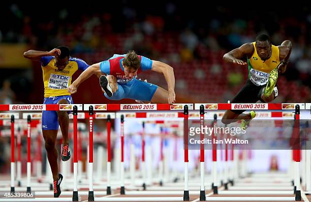 Shane Brathwaite of Barbados, Sergey Shubenkov of Russia and Hansle Parchment of Jamaica compete in the Men's 110 metres hurdles semi-final during...
