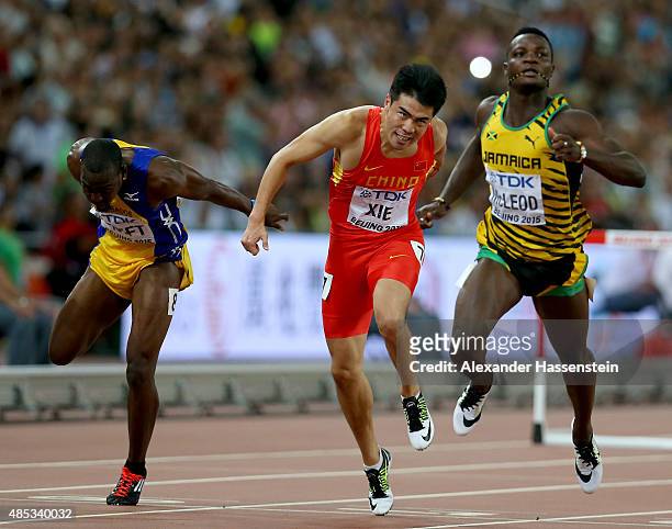 Greggmar Swift of Barbados, Wenjun Xie of China and Omar McLeod of Jamaica compete in the Men's 110 metres hurdles semi-final during day six of the...