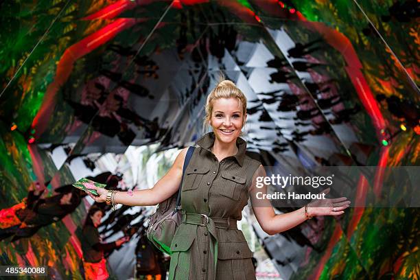 In this handout image supplied by Spark Your City TV Presenter Helen Skelton, interacts with visitors at the 'Spark Your City Urban Jungle' giant...