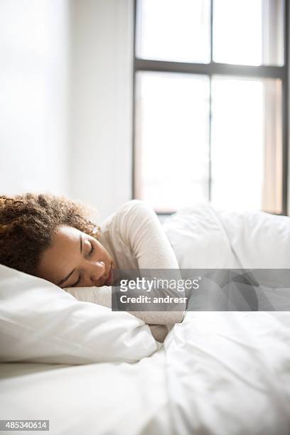 lazy woman in bed - duvet stock pictures, royalty-free photos & images
