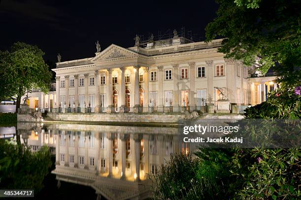 the lazienki palace in lazienki park at night - lazienki park stock pictures, royalty-free photos & images