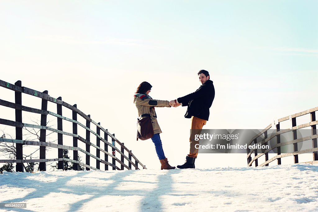 Holding hands in snow walk