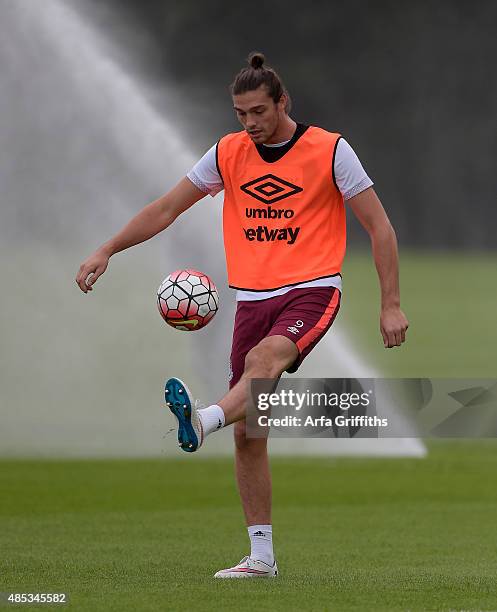 Andy Carroll warms up prior to training at Chadwell Heath on August 27, 2015 in London, England.