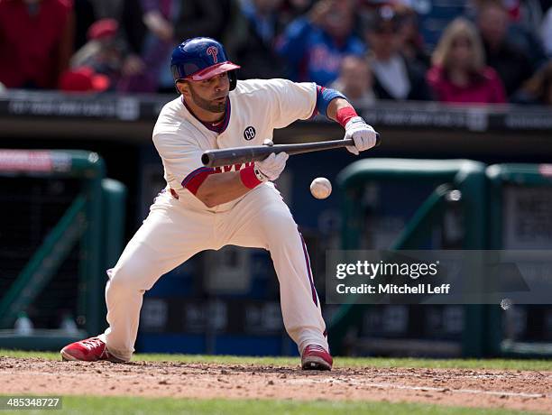 Catcher Wil Nieves of the Philadelphia Phillies bunts the ball in the eighth inning against the Atlanta Braves on April 17, 2014 at Citizens Bank...