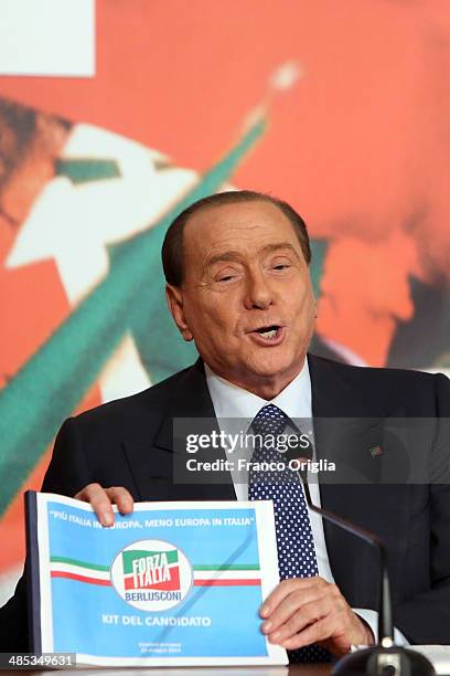 Former Italian Prime Minister Silvio Berlusconi shows the kit for candidates as he holds a press conference to open the European electoral campaign...