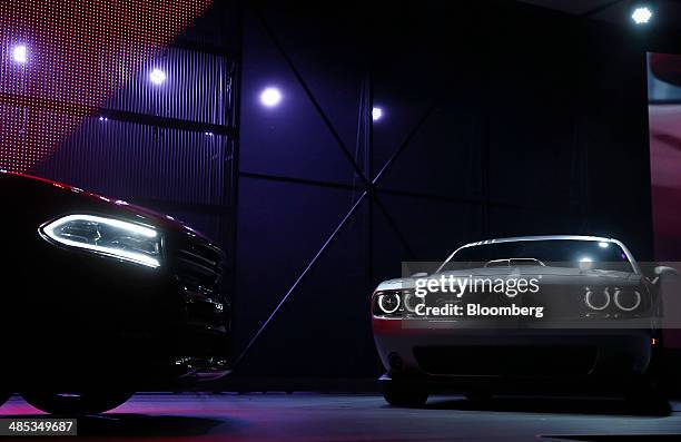 The 2015 Chrysler Group LLC Dodge Charger, left, and Challenger Shaker vehicles are unveiled during the 2014 New York International Auto Show in New...