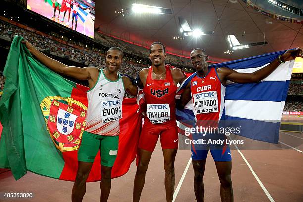 Bronze medalist Nelson Evora of Portugal, gold medalist Christian Taylor of the United States and silver medalist Pedro P. Pichardo of Cuba celebrate...