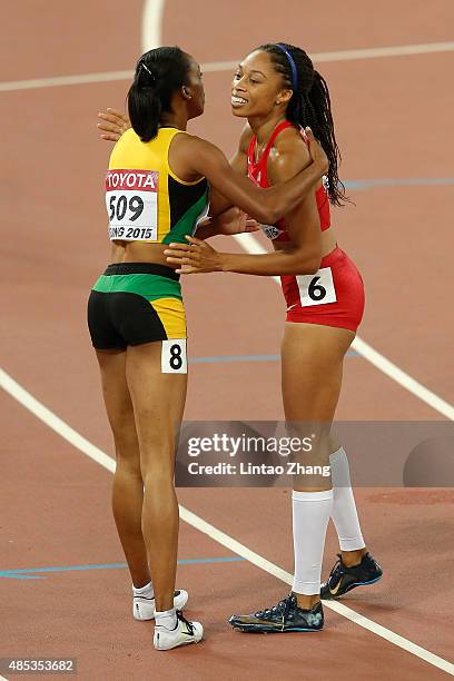 Allyson Felix of the United States is congratulated by Christine Day of Jamaica after winning gold in the Women's 400 metres Final during day six of...