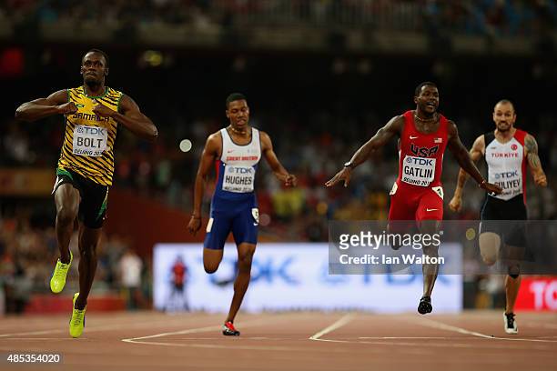 Usain Bolt of Jamaica crosses the finish line to win gold ahead of Justin Gatlin of the United States in the Men's 200 metres final during day six of...
